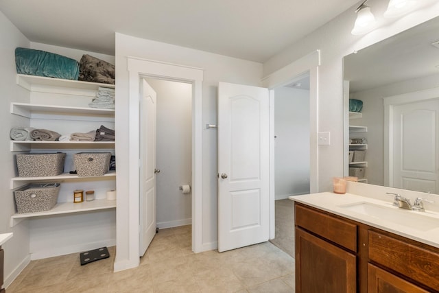 bathroom featuring tile patterned flooring, vanity, and baseboards