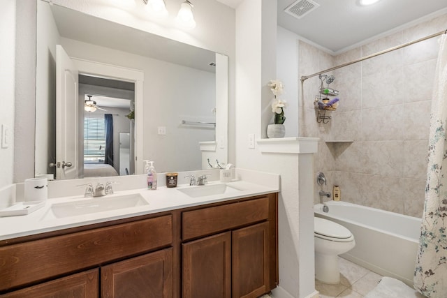 ensuite bathroom with double vanity, connected bathroom, visible vents, and a sink