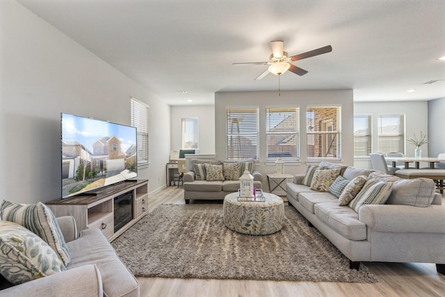 living room with recessed lighting, visible vents, ceiling fan, and wood finished floors