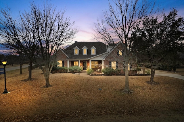 cape cod home with brick siding