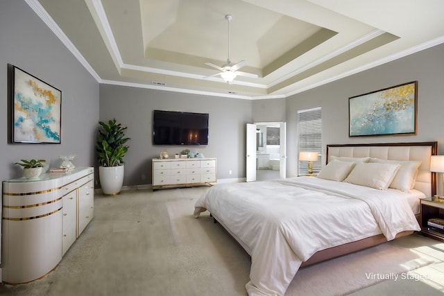 bedroom featuring ornamental molding, a tray ceiling, light colored carpet, and baseboards