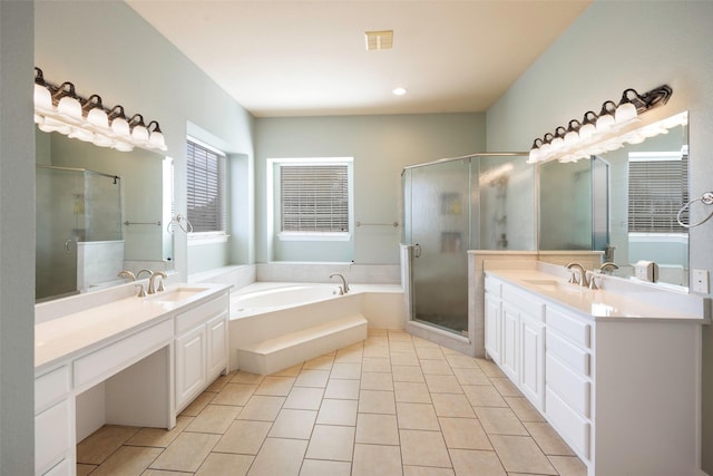 bathroom featuring a shower stall, visible vents, two vanities, and a sink