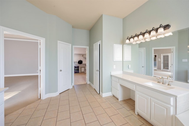 bathroom featuring vanity, baseboards, and tile patterned floors