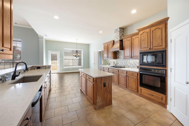 kitchen featuring a wealth of natural light, custom range hood, decorative backsplash, a sink, and black appliances