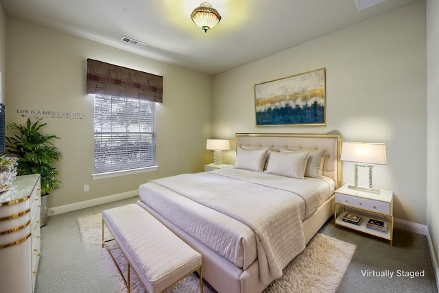 carpeted bedroom featuring visible vents and baseboards