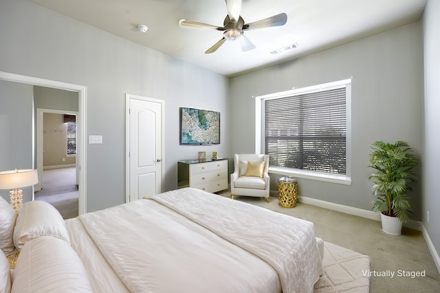 bedroom with carpet floors, visible vents, baseboards, and a ceiling fan