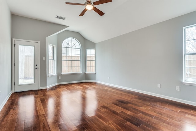 unfurnished room featuring dark wood-type flooring, visible vents, and baseboards