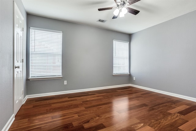 unfurnished room featuring a ceiling fan, baseboards, and wood finished floors