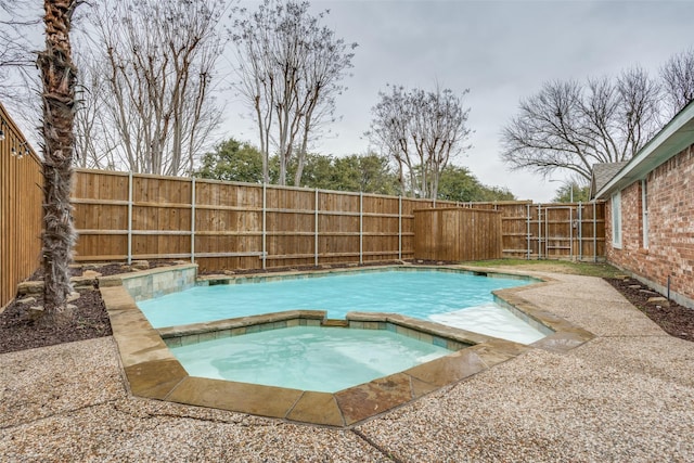 view of pool featuring a fenced backyard, a fenced in pool, and an in ground hot tub