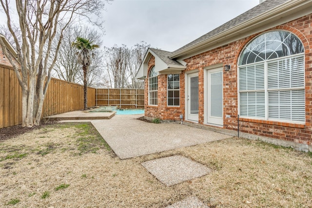 view of yard featuring a patio area, a fenced backyard, and a fenced in pool