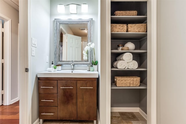 bathroom featuring baseboards, vanity, and built in features