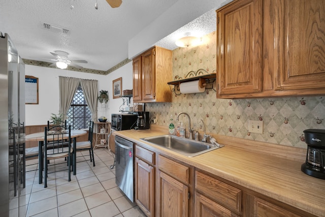 kitchen featuring dishwasher, ceiling fan, light countertops, black microwave, and a sink