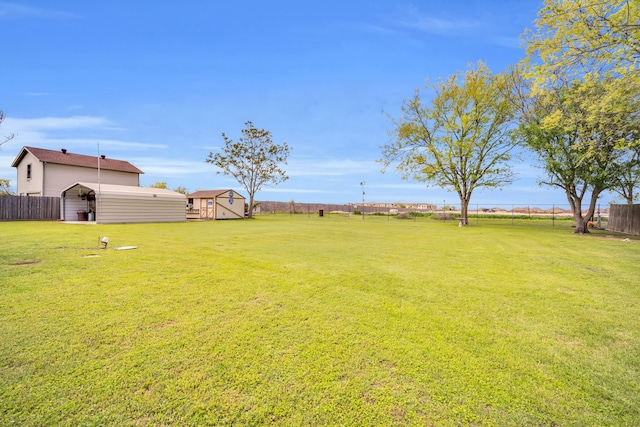 view of yard with an outbuilding and fence