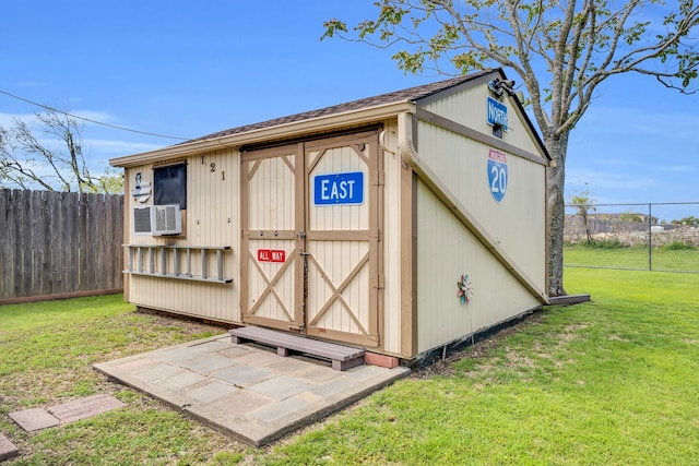 view of shed featuring fence and cooling unit