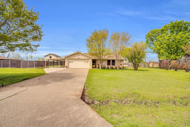 view of front of home featuring driveway, a front lawn, an attached garage, and fence