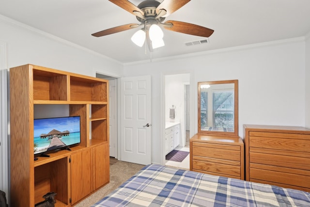 carpeted bedroom featuring a ceiling fan, visible vents, ornamental molding, and connected bathroom