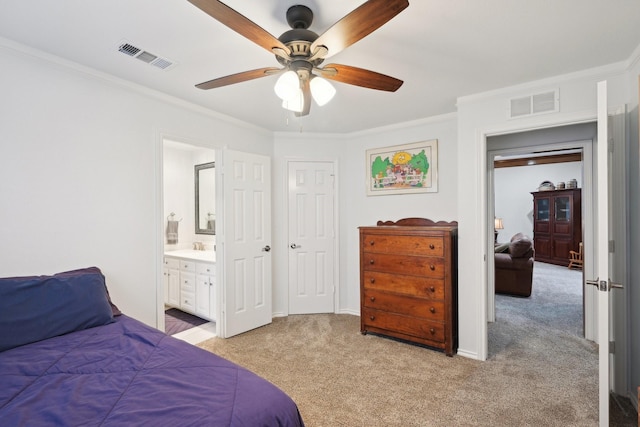 bedroom with ornamental molding, ensuite bath, visible vents, and light colored carpet