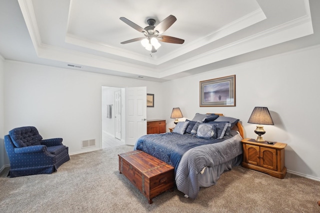 bedroom featuring ornamental molding, a tray ceiling, carpet, and visible vents