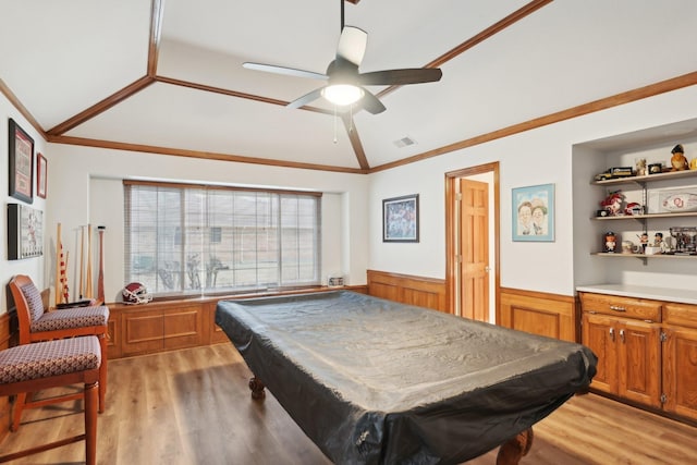 game room with lofted ceiling, a wainscoted wall, billiards, light wood finished floors, and crown molding