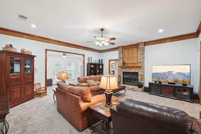 carpeted living room featuring a brick fireplace, visible vents, ornamental molding, and a ceiling fan