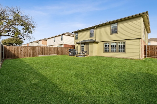 back of house with a lawn, a patio area, and a fenced backyard