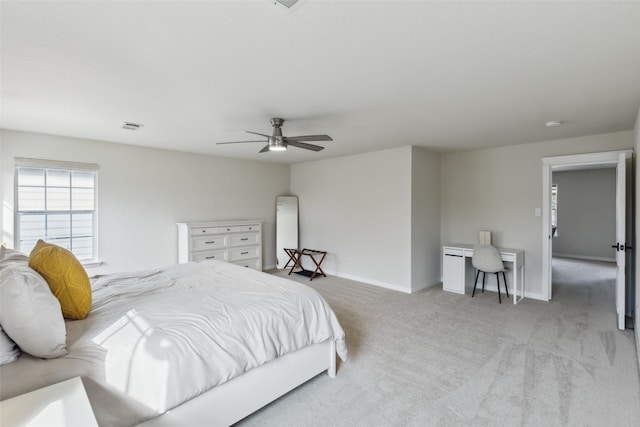 bedroom featuring light carpet, visible vents, baseboards, and a ceiling fan