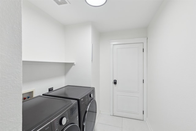 clothes washing area featuring laundry area, light tile patterned floors, baseboards, visible vents, and independent washer and dryer