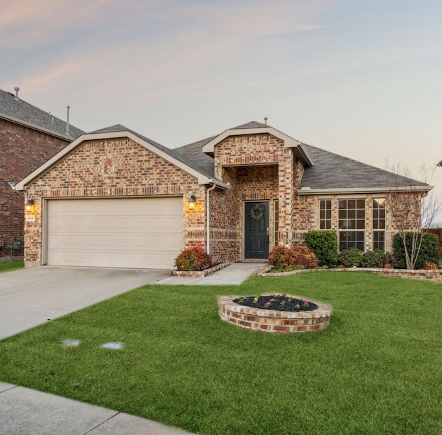 ranch-style house featuring a front yard, an attached garage, a shingled roof, concrete driveway, and brick siding