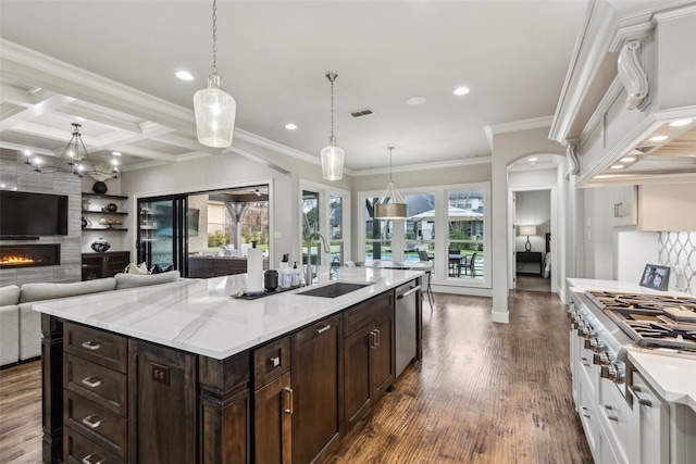 kitchen featuring a fireplace, visible vents, appliances with stainless steel finishes, a sink, and coffered ceiling