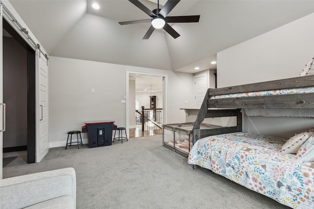 carpeted bedroom with high vaulted ceiling, a barn door, recessed lighting, and baseboards