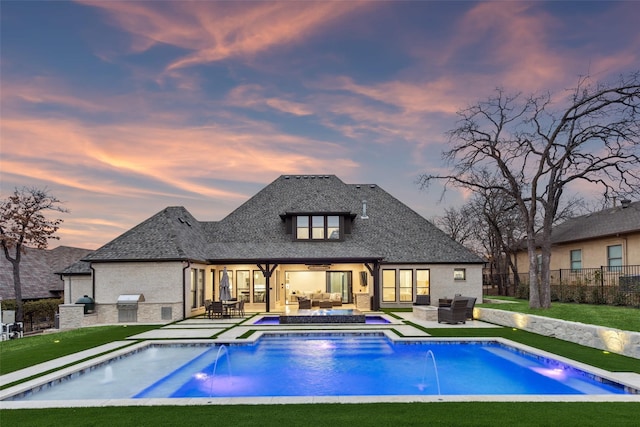 view of swimming pool with central AC unit, a grill, fence, exterior kitchen, and an outdoor living space