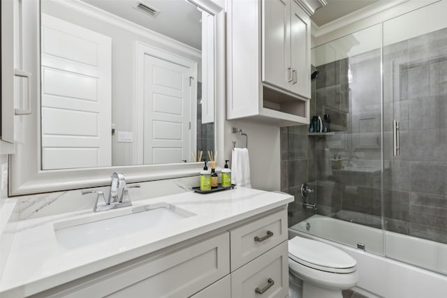 full bath with shower / bath combination with glass door, crown molding, visible vents, toilet, and vanity