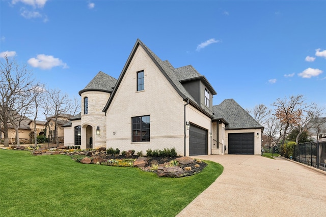 view of front of home with a garage, concrete driveway, fence, a front lawn, and brick siding