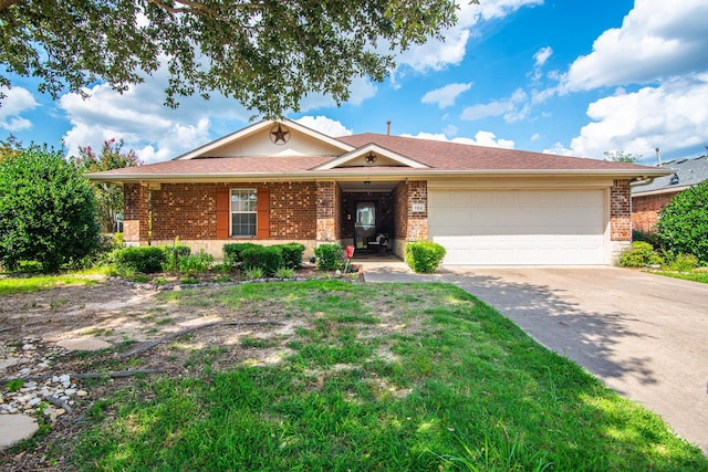 single story home with a garage, brick siding, driveway, and a front lawn