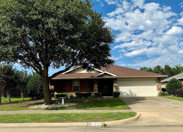 ranch-style home with driveway, a garage, a front lawn, and brick siding