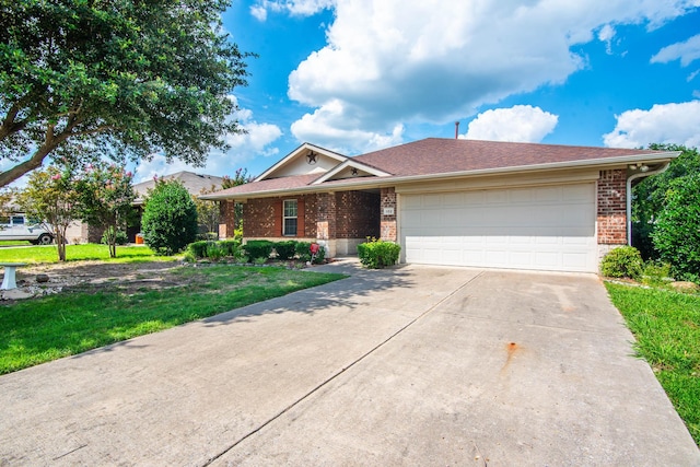 ranch-style home featuring a garage, concrete driveway, brick siding, and a front yard