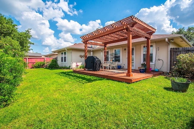 back of house with a lawn, fence, a wooden deck, a pergola, and stucco siding