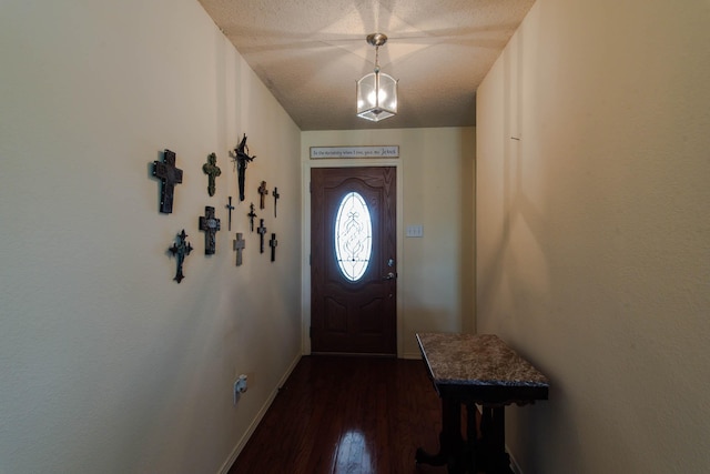 doorway to outside featuring dark wood-style floors and baseboards