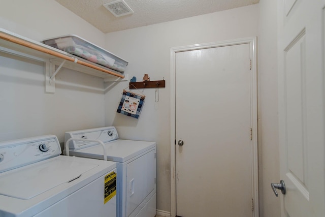 laundry room featuring laundry area, visible vents, independent washer and dryer, and a textured ceiling