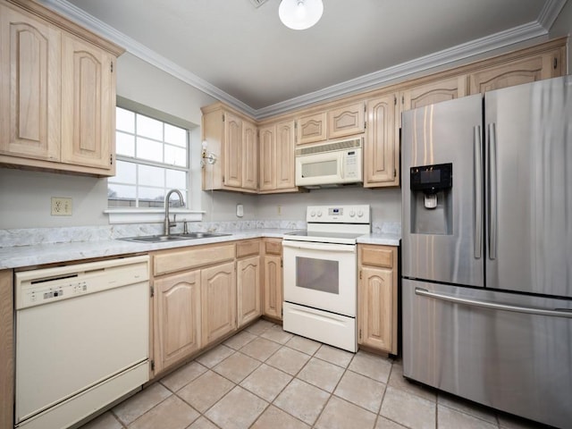 kitchen featuring white appliances, light brown cabinets, light countertops, and a sink