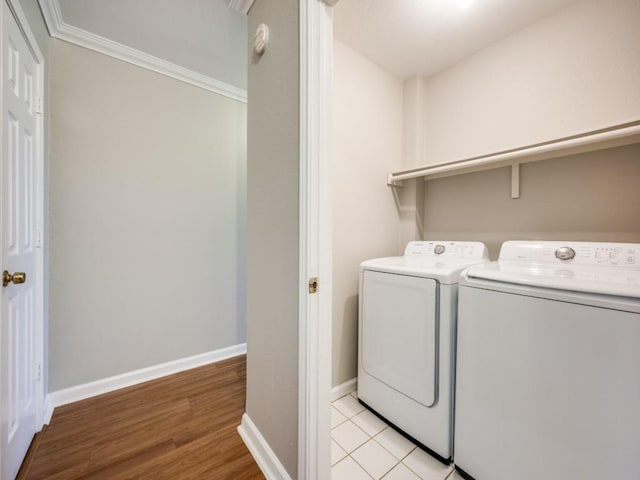 laundry room featuring light wood-type flooring, washer and dryer, laundry area, and baseboards