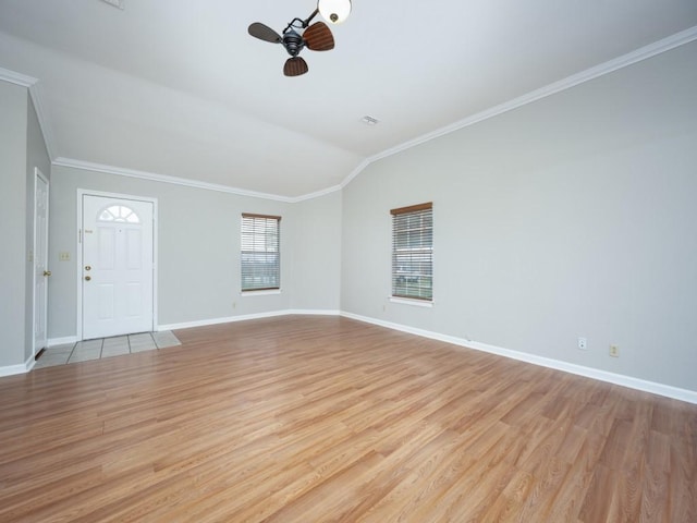 unfurnished living room with light wood-type flooring, ceiling fan, ornamental molding, and baseboards