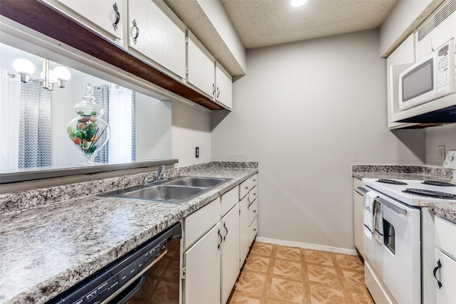 kitchen with a textured ceiling, white appliances, a sink, baseboards, and white cabinets