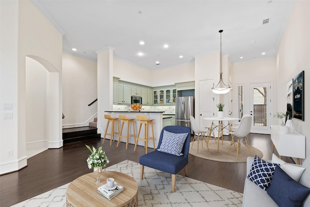 living room featuring recessed lighting, wood finished floors, visible vents, and stairs