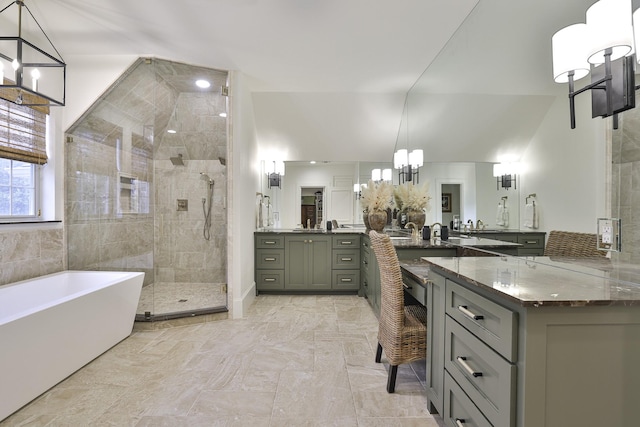 bathroom with a soaking tub, a shower stall, a chandelier, and vanity