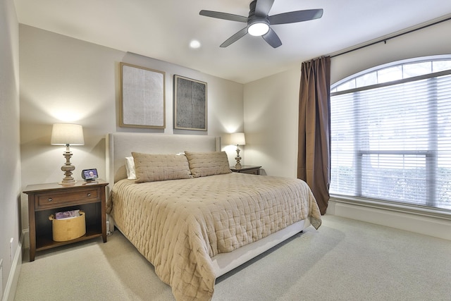 bedroom featuring light carpet and ceiling fan