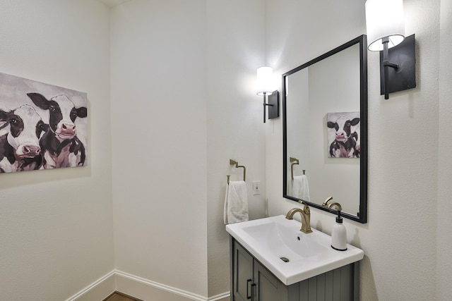 bathroom with baseboards and vanity