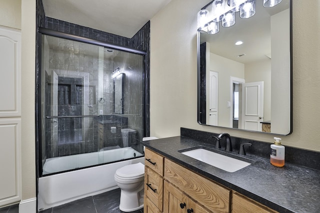 full bath featuring toilet, tile patterned floors, bath / shower combo with glass door, and vanity