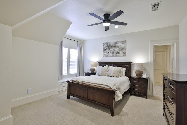 bedroom with light carpet, a ceiling fan, visible vents, and baseboards