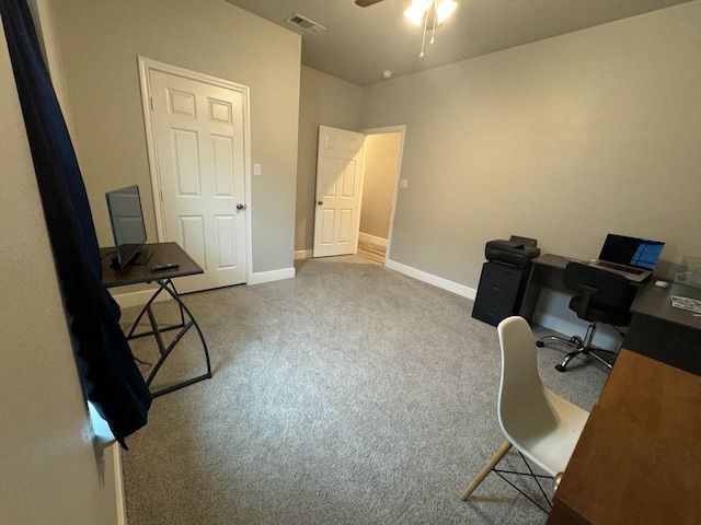 office space with baseboards, carpet flooring, ceiling fan, and visible vents